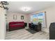 Bedroom featuring wood-look tile, trundle bed, and a view of the lake at 6999 W Country Club N Dr # 224, Sarasota, FL 34243