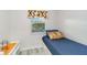 Cozy bedroom with a twin bed, colorful pillow, and a window with a view at 6999 W Country Club N Dr # 224, Sarasota, FL 34243