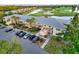 An aerial view shows a well-maintained condo building with ample parking and lush landscaping at 6999 W Country Club N Dr # 224, Sarasota, FL 34243