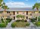 Charming condo building featuring private balconies, neat landscaping, and inviting walkways at 6999 W Country Club N Dr # 224, Sarasota, FL 34243