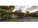View of the Palm Aire Country Club entrance with its porte cochere and tile roof at 6999 W Country Club N Dr # 224, Sarasota, FL 34243