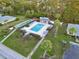 Aerial view of a community pool area with lounge chairs and palm trees, surrounded by well-maintained landscaping at 6999 W Country Club N Dr # 224, Sarasota, FL 34243