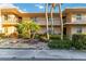 Inviting condo exterior featuring a balcony, lush landscaping, and a well-maintained facade at 6999 W Country Club N Dr # 224, Sarasota, FL 34243