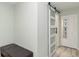 Hallway with a modern, frosted glass sliding door and storage closet at 6999 W Country Club N Dr # 224, Sarasota, FL 34243
