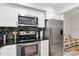 Updated kitchen featuring stainless steel appliances, white cabinets, and tile flooring at 6999 W Country Club N Dr # 224, Sarasota, FL 34243
