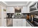 Bright updated kitchen featuring stainless appliances, granite countertops and a view out to the lanai at 6999 W Country Club N Dr # 224, Sarasota, FL 34243