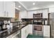 Updated kitchen with granite countertops, stainless steel appliances, and subway tile backsplash at 6999 W Country Club N Dr # 224, Sarasota, FL 34243