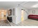 Open concept living room with a TV, console table, and a daybed in the background at 6999 W Country Club N Dr # 224, Sarasota, FL 34243