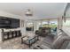 Relaxing living room with a view, comfortable seating, and a modern entertainment center at 6999 W Country Club N Dr # 224, Sarasota, FL 34243