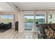 Bright living room with a view of a golf course, home office, and a sliding glass door to the patio at 6999 W Country Club N Dr # 224, Sarasota, FL 34243