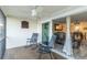 Screened-in lanai with tile flooring, rocking chairs, and a view to the home's interior at 6999 W Country Club N Dr # 224, Sarasota, FL 34243