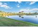 A serene pond reflects palm trees and blue skies on a lush golf course, creating a picturesque and inviting scene at 6999 W Country Club N Dr # 224, Sarasota, FL 34243