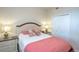 Comfortable bedroom with a queen bed, floral pillows, and and nightstands at 7005 River Hammock Dr # 204, Bradenton, FL 34212