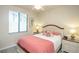 Cozy bedroom with a queen bed, bright pillows, and natural light from the window at 7005 River Hammock Dr # 204, Bradenton, FL 34212