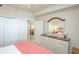 Bright bedroom features a dresser with a mirror and decor and closet for ample storage at 7005 River Hammock Dr # 204, Bradenton, FL 34212