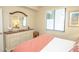Bright bedroom with a large window, ample storage in the dresser, and coastal-inspired decor at 7005 River Hammock Dr # 204, Bradenton, FL 34212