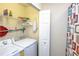 Functional laundry area with a washer, dryer, shelving, and extra storage space at 7005 River Hammock Dr # 204, Bradenton, FL 34212