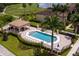 Aerial view of the community pool, outdoor kitchen, and comfortable lounge seating at 7005 River Hammock Dr # 204, Bradenton, FL 34212