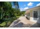 Covered patio area showing view to the landscaped backyard and white trim at 7202 18Th Nw Ave, Bradenton, FL 34209