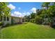 Landscaped backyard with lush green lawn and tropical plants at 7202 18Th Nw Ave, Bradenton, FL 34209