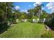 Beautiful landscaped backyard with lush green lawn and tropical plants at 7202 18Th Nw Ave, Bradenton, FL 34209