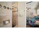Bathroom with a tiled shower and a view into the bedroom with vibrant flamingo themed decor at 7202 18Th Nw Ave, Bradenton, FL 34209