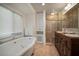 Bathroom features a large soaking tub, storage, and a glass shower enclosure at 7202 18Th Nw Ave, Bradenton, FL 34209