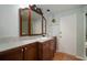 Cozy bathroom featuring wood cabinets, a single sink, and white beadboard walls at 7202 18Th Nw Ave, Bradenton, FL 34209