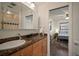 Bright bathroom featuring a marble countertop, wooden cabinets, and a view into the bedroom at 7202 18Th Nw Ave, Bradenton, FL 34209