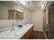 Bright bathroom featuring double sinks, stylish lighting, and a glass shower at 7202 18Th Nw Ave, Bradenton, FL 34209