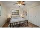 Well-lit bedroom with a metal-framed bed, wooden floors, and ample closet space at 7202 18Th Nw Ave, Bradenton, FL 34209