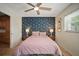 Primary bedroom featuring a decorative blue wall, ceiling fan, and natural light at 7202 18Th Nw Ave, Bradenton, FL 34209