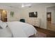 Bright bedroom features hardwood floors, a white dresser, and a mounted TV at 7202 18Th Nw Ave, Bradenton, FL 34209