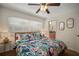 Light and bright bedroom with tropical bedding, ceiling fan, and ensuite bathroom at 7202 18Th Nw Ave, Bradenton, FL 34209