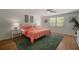 Bright bedroom featuring wood floors, a ceiling fan, and tropical-themed decor at 7202 18Th Nw Ave, Bradenton, FL 34209