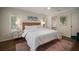 Bright bedroom with hardwood floors, a window, and palm tree-themed artwork at 7202 18Th Nw Ave, Bradenton, FL 34209