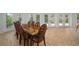 Elegant dining room with intricate chairs and French doors welcomes natural light and outdoor views at 7202 18Th Nw Ave, Bradenton, FL 34209