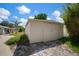 Backyard view of a detached garage with double doors and mature landscaping at 7202 18Th Nw Ave, Bradenton, FL 34209