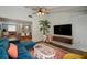 Inviting living room featuring a blue sofa, tropical plants and open view to the dining area at 7202 18Th Nw Ave, Bradenton, FL 34209