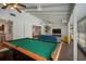 Spacious living area featuring a pool table, large sectional, and easy kitchen access at 7202 18Th Nw Ave, Bradenton, FL 34209