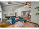 Open living room featuring a blue sofa, a pool table, and polished concrete floors at 7202 18Th Nw Ave, Bradenton, FL 34209