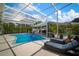 A refreshing backyard pool area with lounge chairs and a screened enclosure for outdoor enjoyment at 7202 18Th Nw Ave, Bradenton, FL 34209