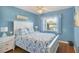 Serene bedroom featuring a white bed frame, colorful bedding, and a ceiling fan at 7301 29Th Avenue W Dr # 108, Bradenton, FL 34209