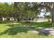 Well-maintained community area featuring a shuffleboard court, picnic tables, and benches shaded by mature trees at 7301 29Th Avenue W Dr # 108, Bradenton, FL 34209