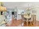 Bright dining area with wood floors, stylish table set, and convenient pass-through to the kitchen at 7301 29Th Avenue W Dr # 108, Bradenton, FL 34209