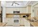 Well-maintained kitchen features white cabinetry, granite counters, and modern appliances at 7301 29Th Avenue W Dr # 108, Bradenton, FL 34209