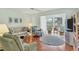 Inviting living room featuring an area rug and access to the sunroom and other living spaces at 7301 29Th Avenue W Dr # 108, Bradenton, FL 34209
