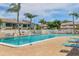Inviting community pool with ample lounge chairs, lush landscaping, and well-maintained pool deck at 7301 29Th Avenue W Dr # 108, Bradenton, FL 34209