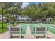 Community shuffleboard court featuring benches with shade trees and surrounding landscaping at 7301 29Th Avenue W Dr # 108, Bradenton, FL 34209
