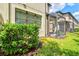 A home exterior showcases a screened patio and lush landscaping at 7844 52Nd E Ter, Bradenton, FL 34203